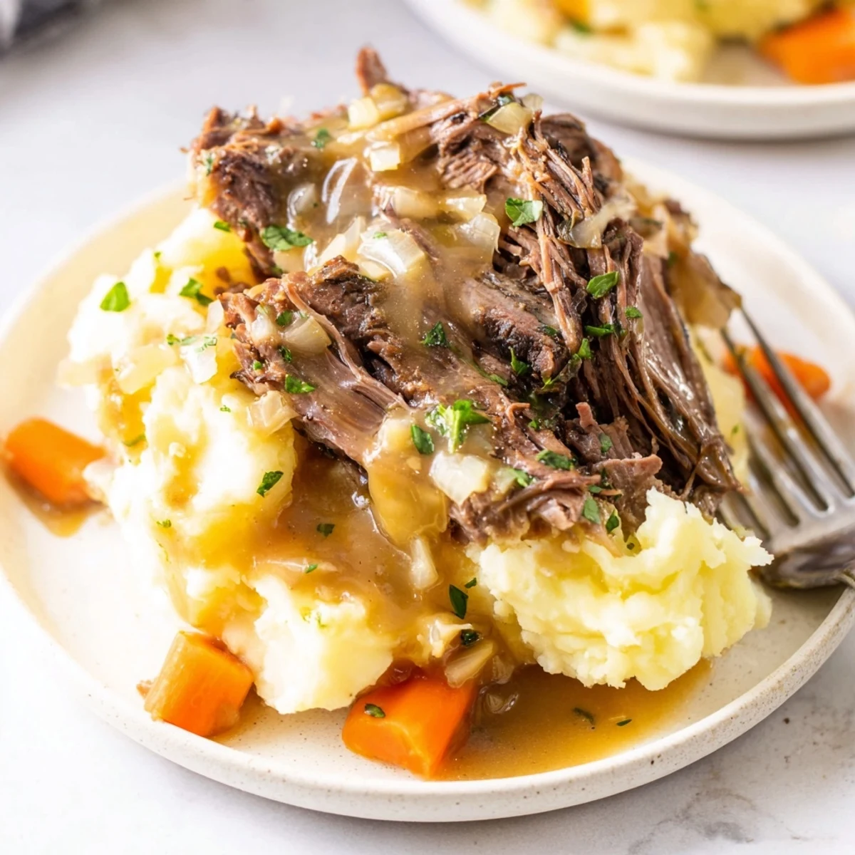 Aromatic Slow Cooker Pot Roast with Mashed Potatoes, rich gravy and veggies complementing each bite.  