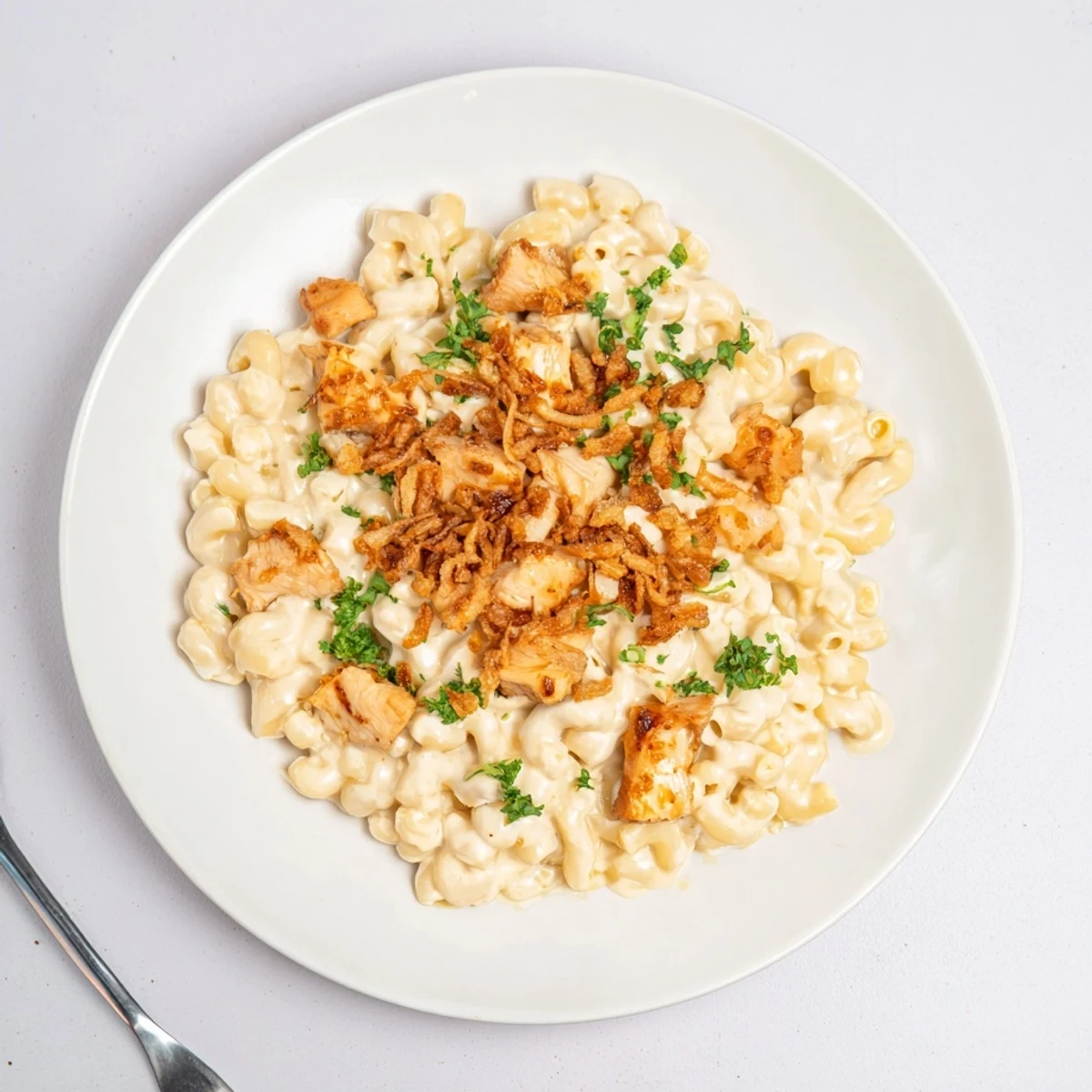 Creamy One-Pot Honey BBQ Chicken Mac and Cheese topped with crunchy onions and parsley.  