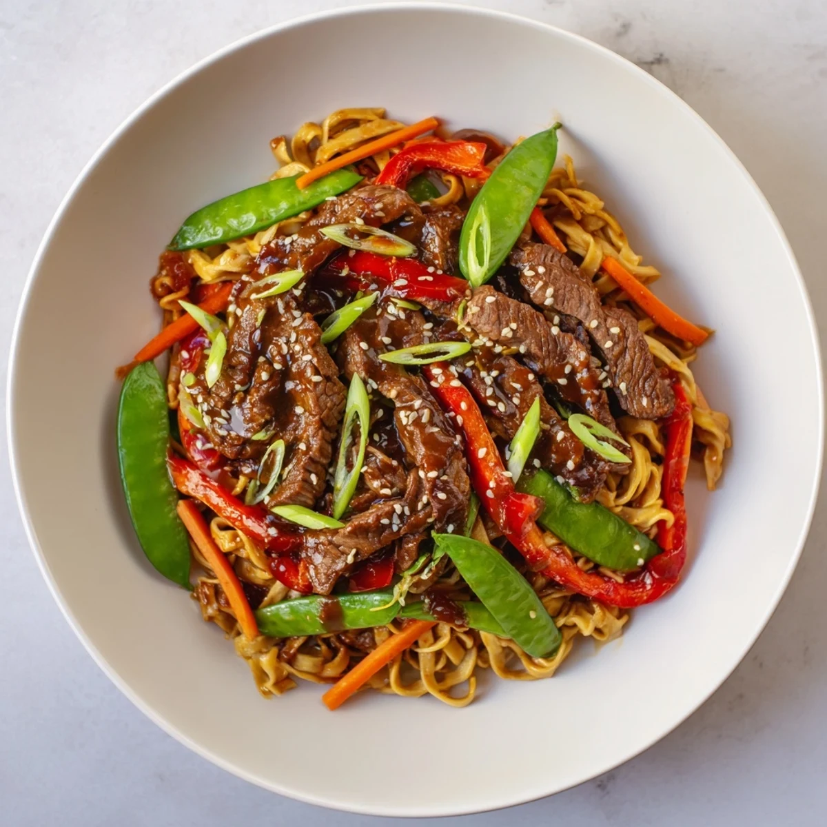 Steaming Teriyaki Beef & Noodle Bowl with tender beef, colorful veggies, and a glossy teriyaki glaze.