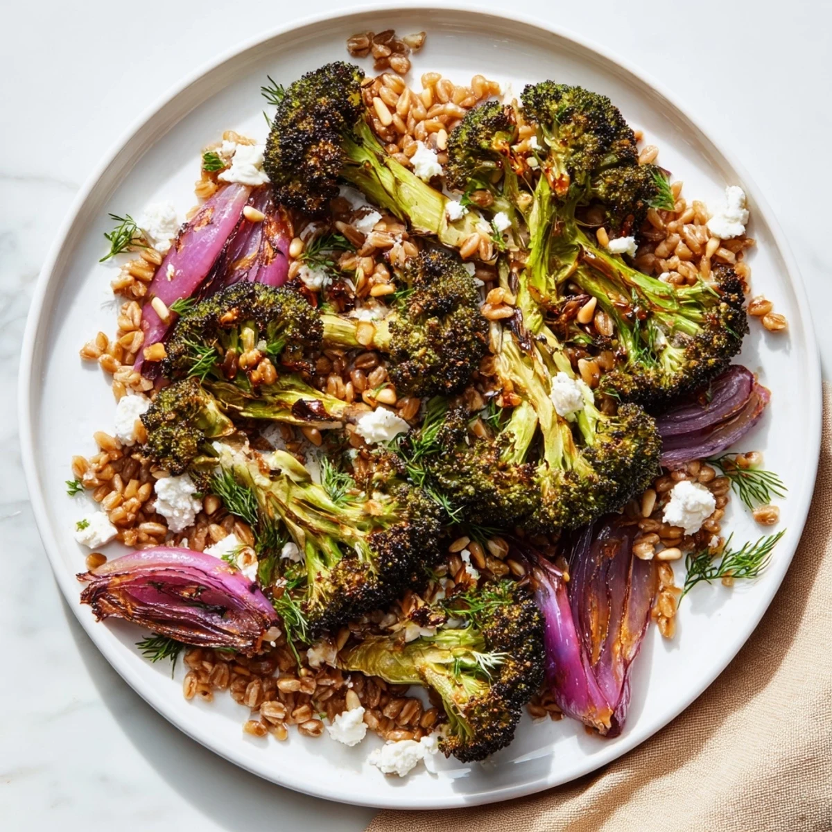 Golden roasted broccoli tossed with lemon-garlic dressing served over fluffy farro, a vibrant dish.