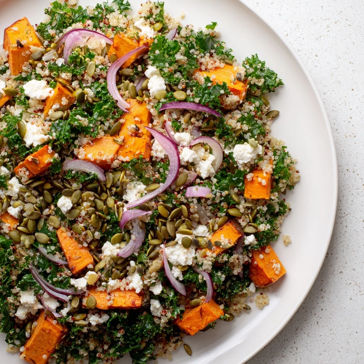 This healthy Kale & Quinoa Salad highlights tender kale, fluffy quinoa, and sweet roasted sweet potatoes.
