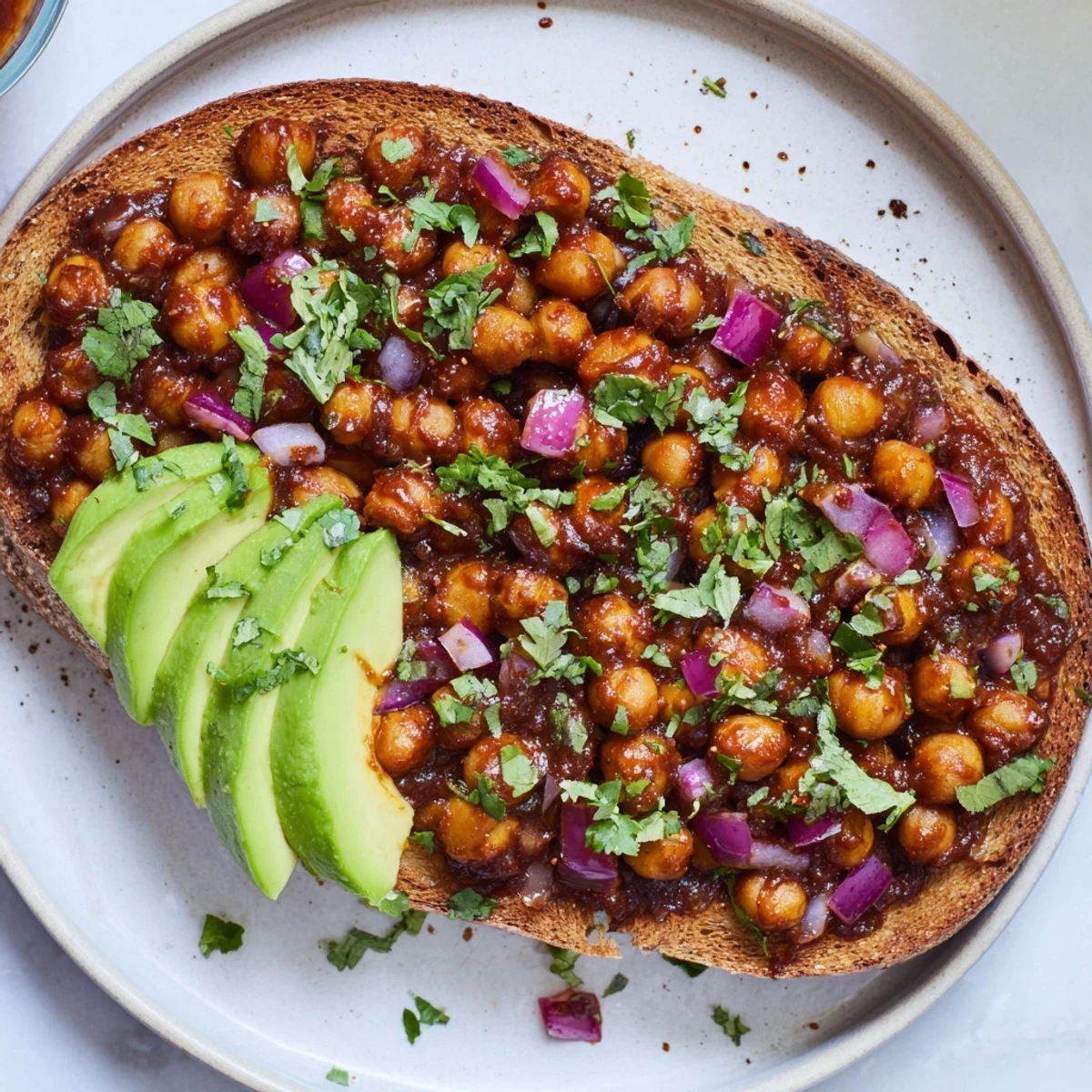 Golden slices of toast topped with flavorful, saucy BBQ Chickpeas, a vegan delight.