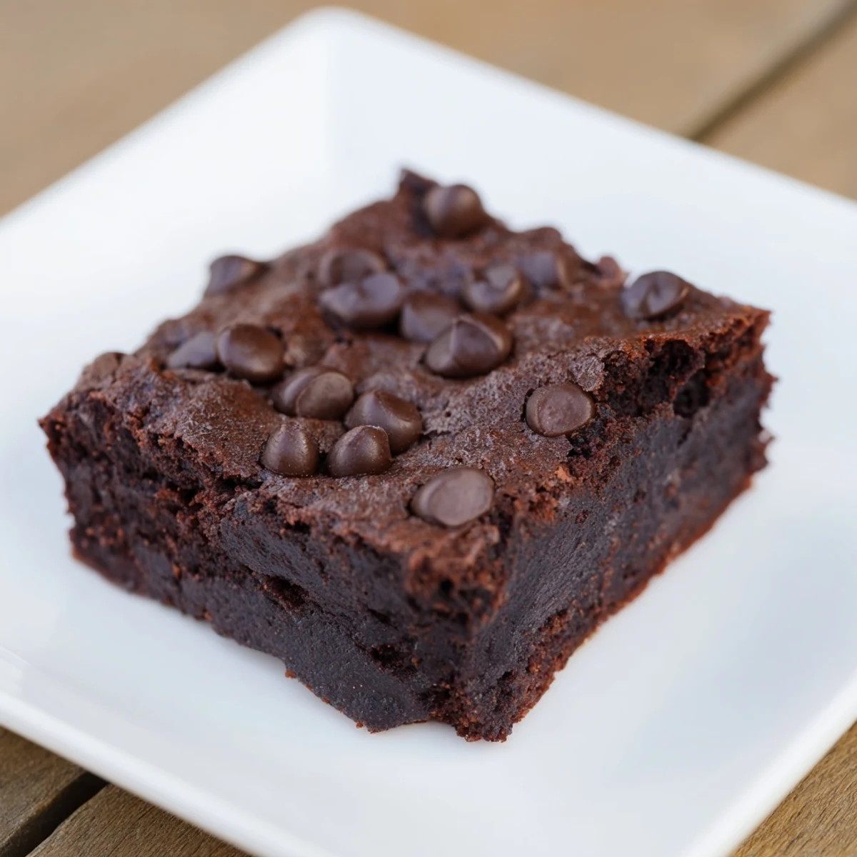 Fudgy and delicious Black Bean Brownies, perfect chocolate treats with visible chocolate chip topping, ready to be enjoyed.