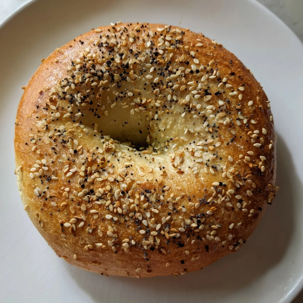 Warm, bubbling water poaching the homemade budget bagels before they’re baked to perfection.
