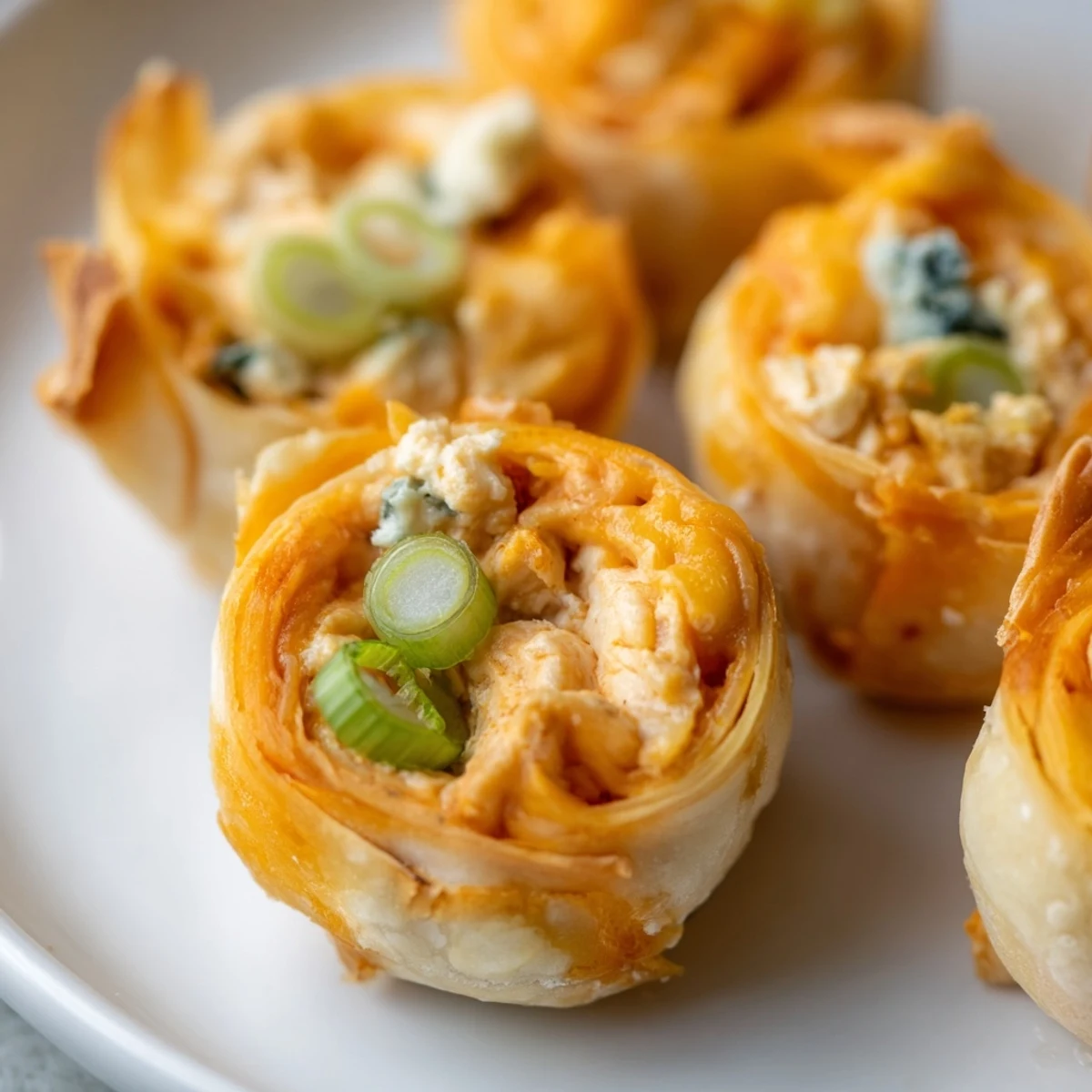 Golden and crisp Buffalo Chicken Dip Pinwheel Wontons, a perfect party appetizer ready to eat.