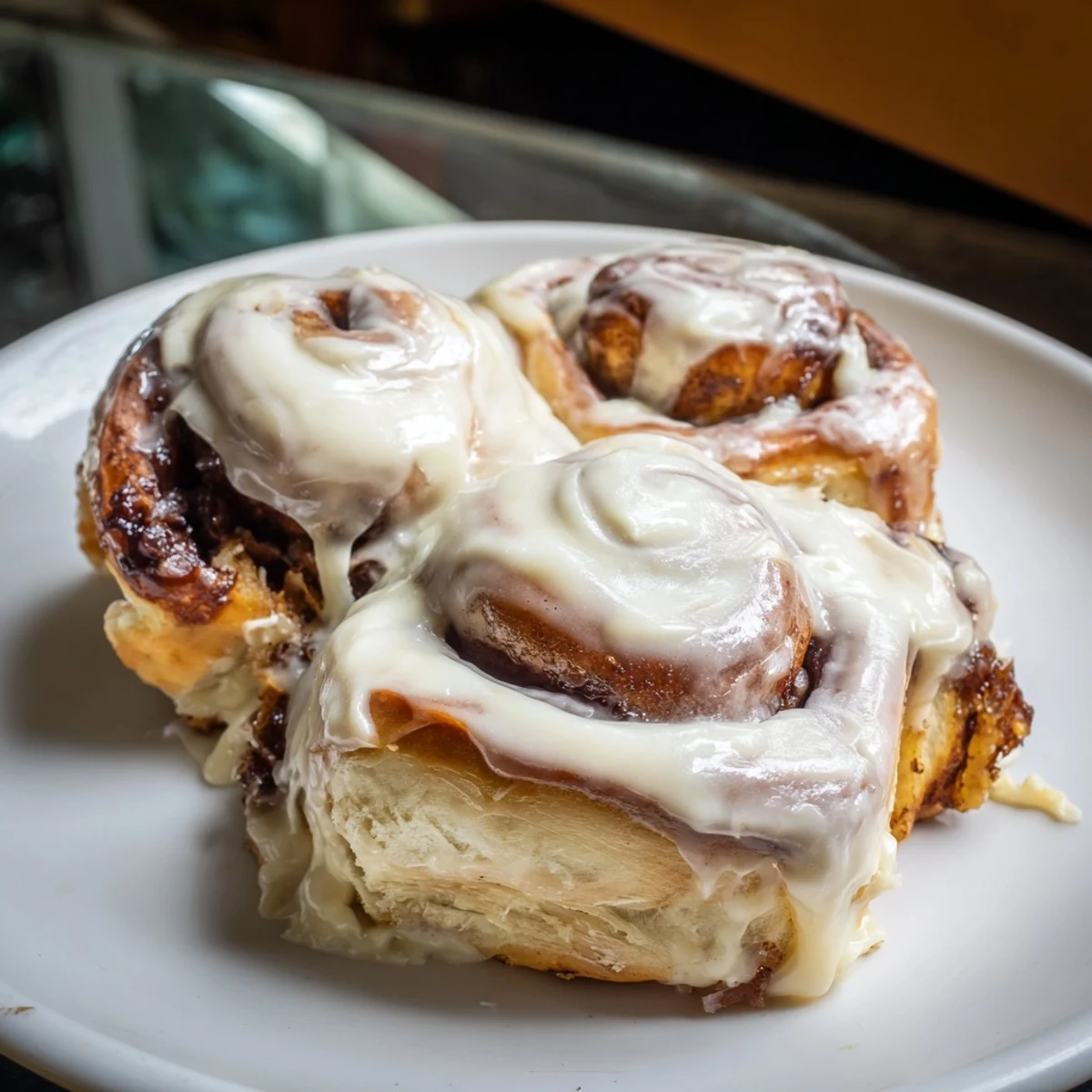 Golden-brown TikTok Heavy Cream Cinnamon Rolls, soft rolls rising in a baking dish, ready for icing.