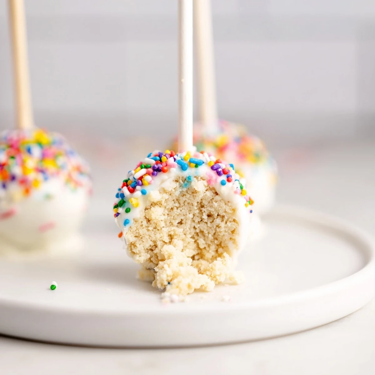 Close-up of freshly made Lightened-Up Sugar Cookie Cake Pops, a delicious, bite-sized dessert with sprinkles.
