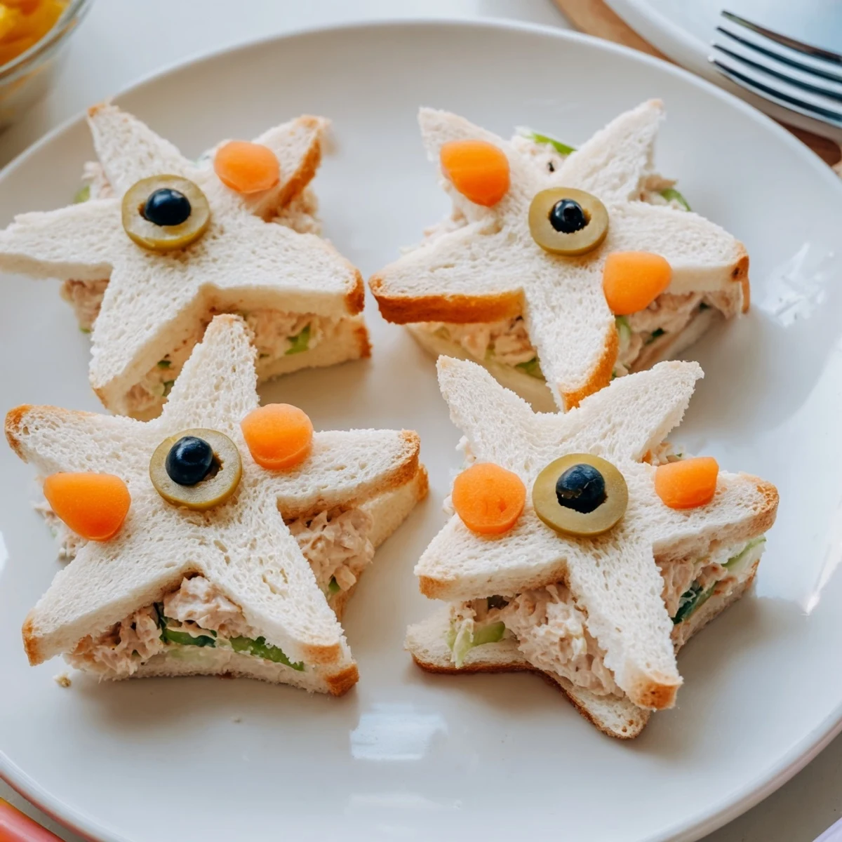 Close-up of delightful Mini Starfish Sandwiches, a fun, kid-friendly appetizer with olive and caper details.