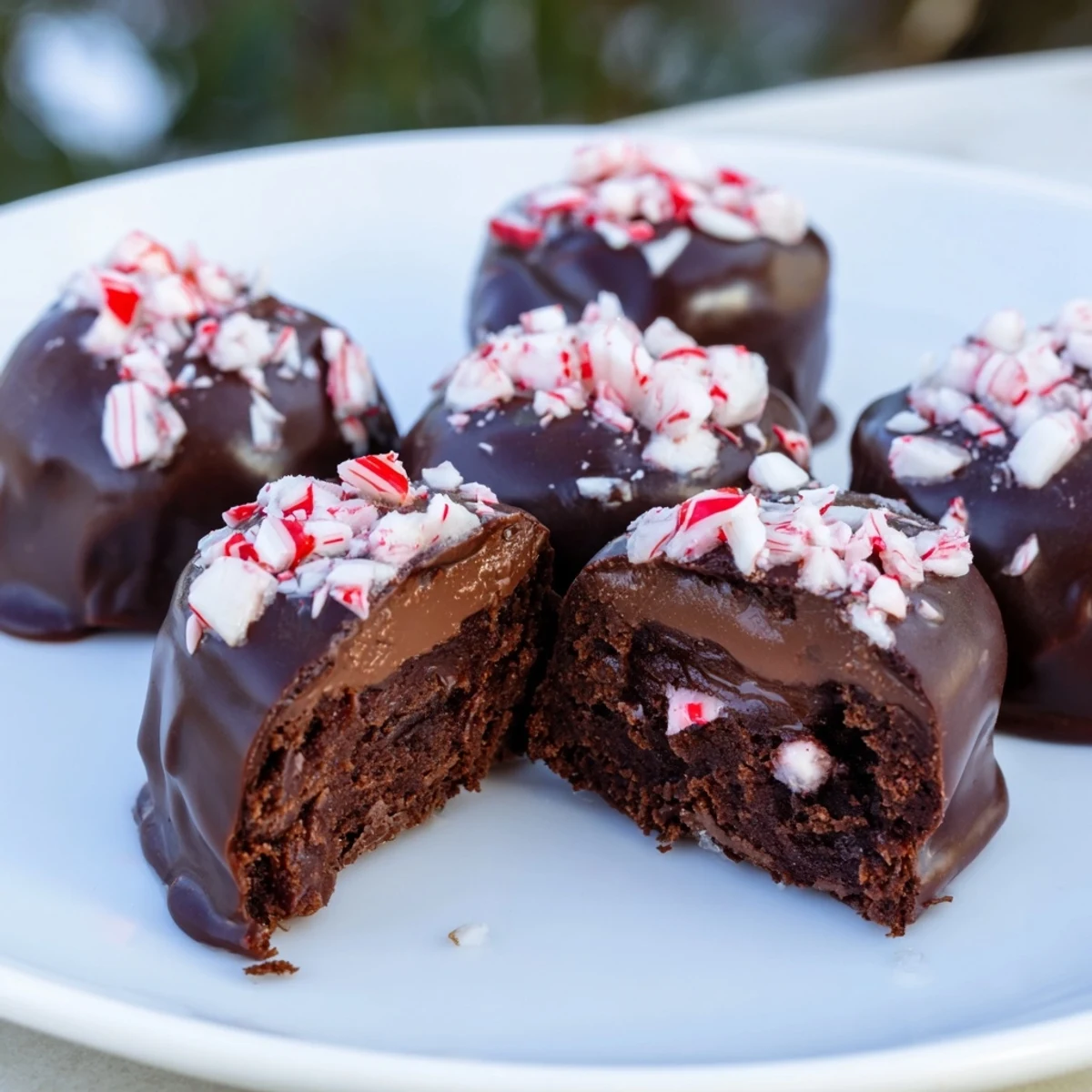 Warm, melty Peppermint Mocha Brownie Bites, rich and dark with a generous chocolate glaze, look irresistible.