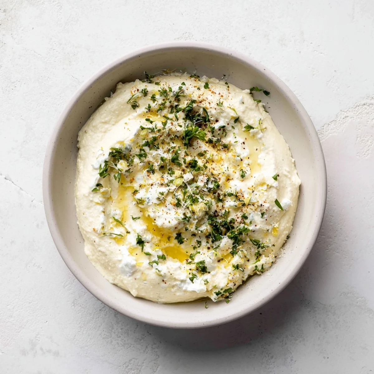 This vibrant dish of Angel Wings whipped feta, with a sprinkle of herbs, served with pita chips.