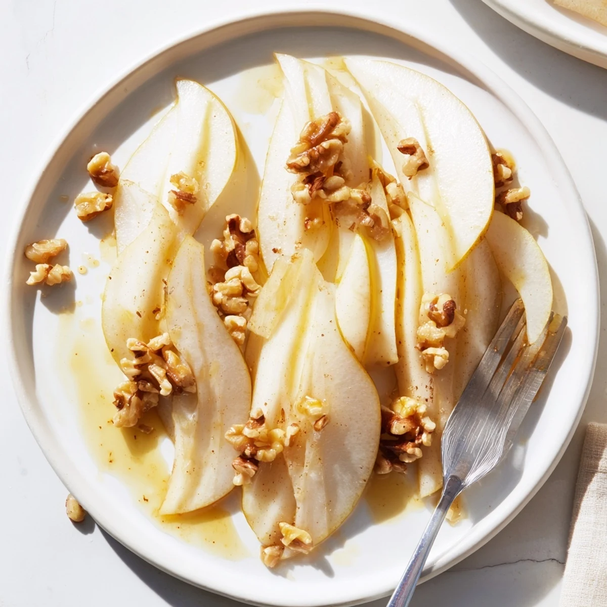 Thinly sliced pears with sweet honey drizzled over, ready for a delicious, quick snack.