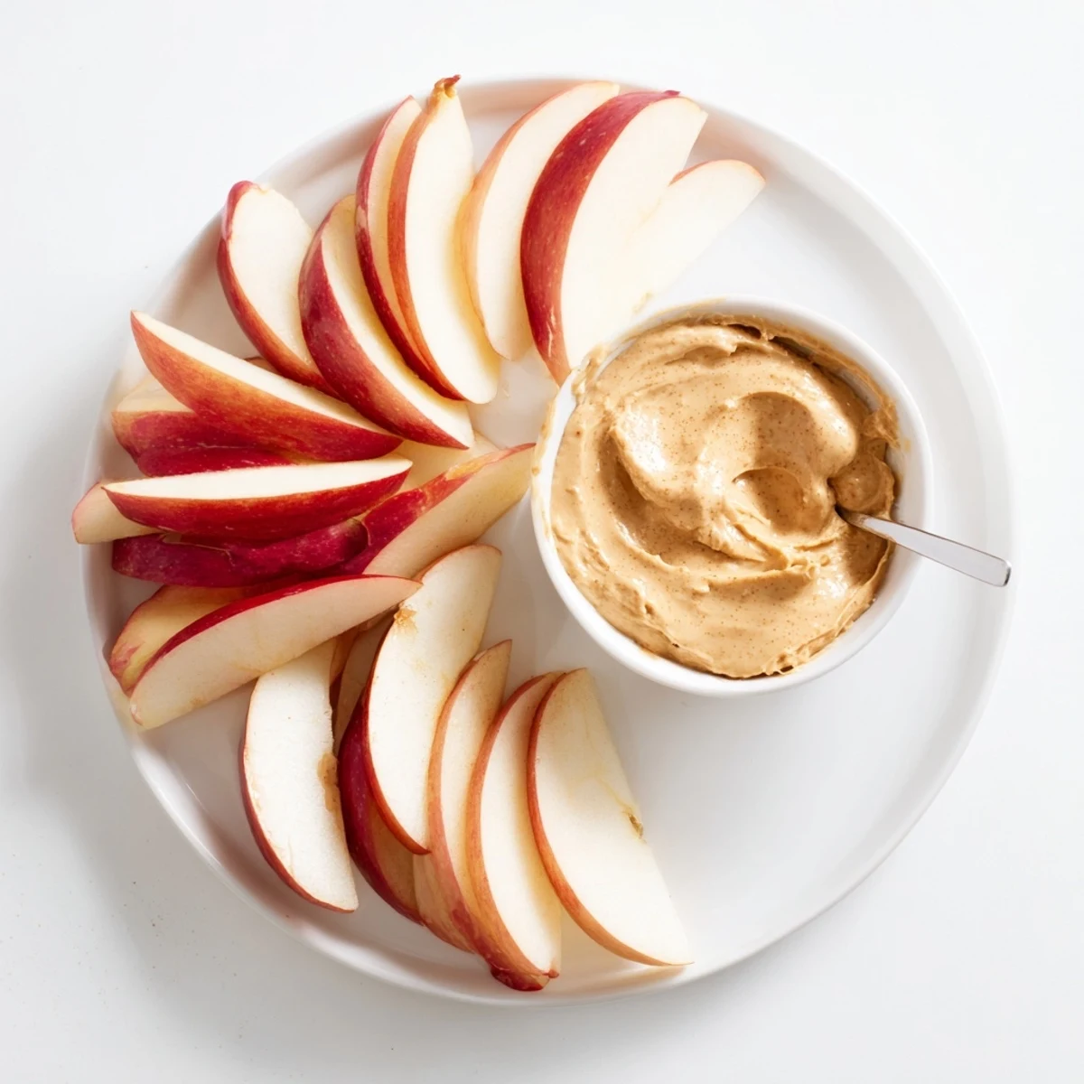 Crisp apple slices ready to be dipped into a creamy peanut butter dip for a delightful snack.