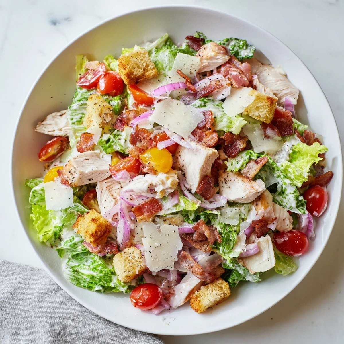 Costco Chicken Bake Salad Bowl with crisp romaine, bacon, and a creamy Caesar dressing, a delightful lunch.