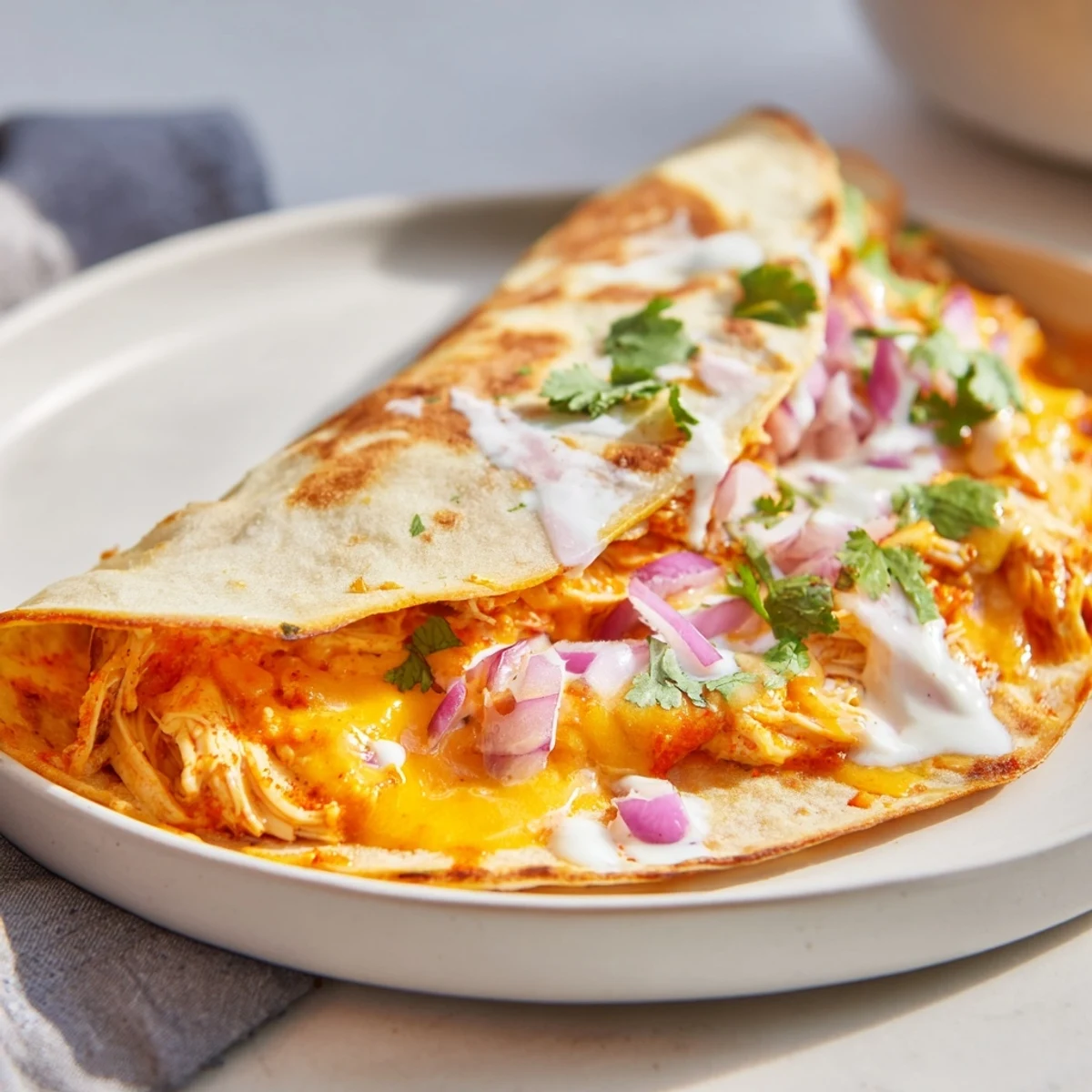 Golden, crispy Buffalo Chicken Quesadilla, oozing with melted cheese and spicy chicken.