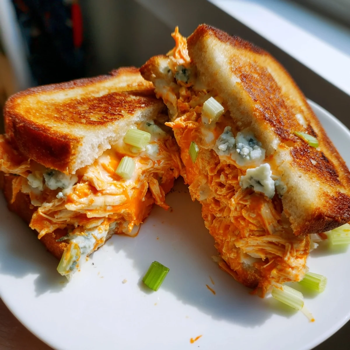 Golden Buffalo Chicken Grilled Cheese sandwich with melted cheese & crispy, toasted bread.