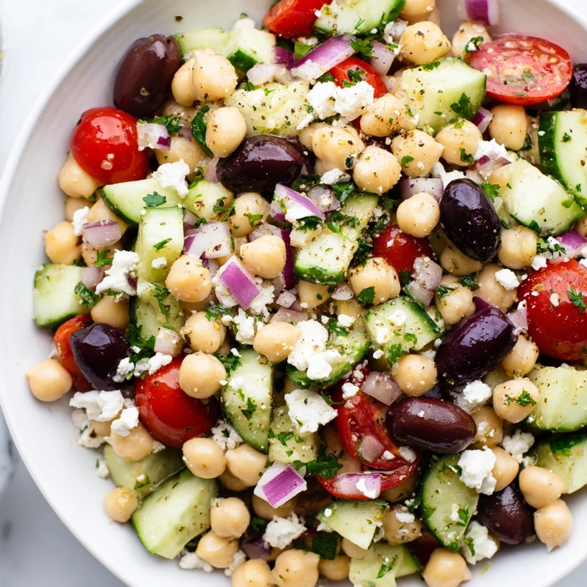 Mediterranean Chickpea Salad, bursting with colorful veggies and creamy feta, drizzled with zesty lemon dressing.
