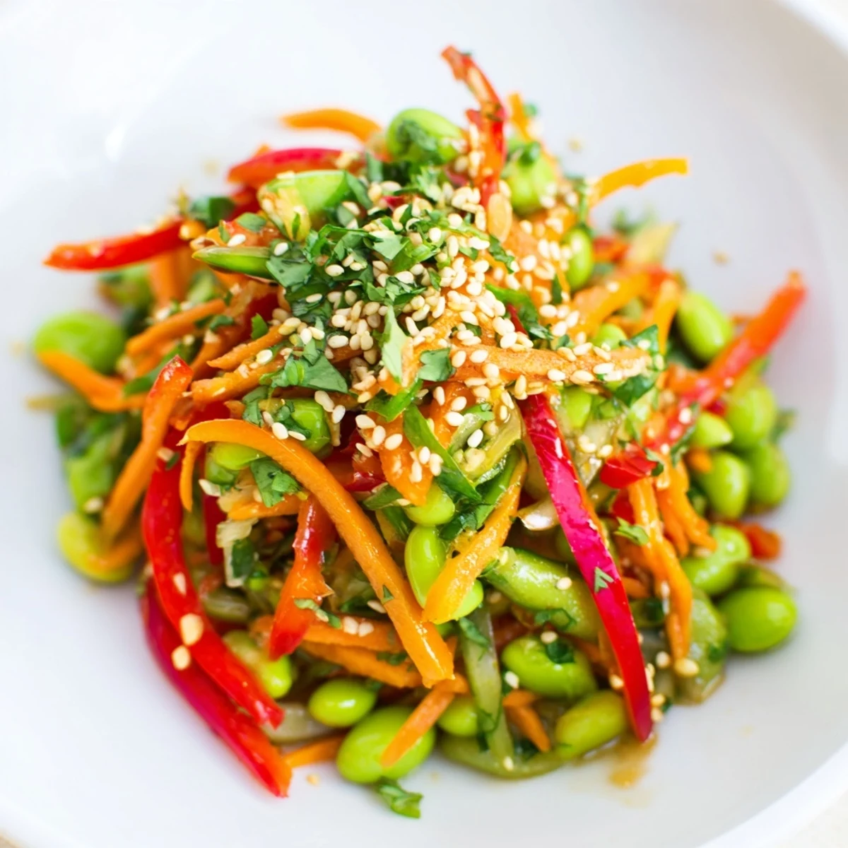 Fresh Asian edamame salad with sesame ginger dressing, a colorful and vibrant dish.