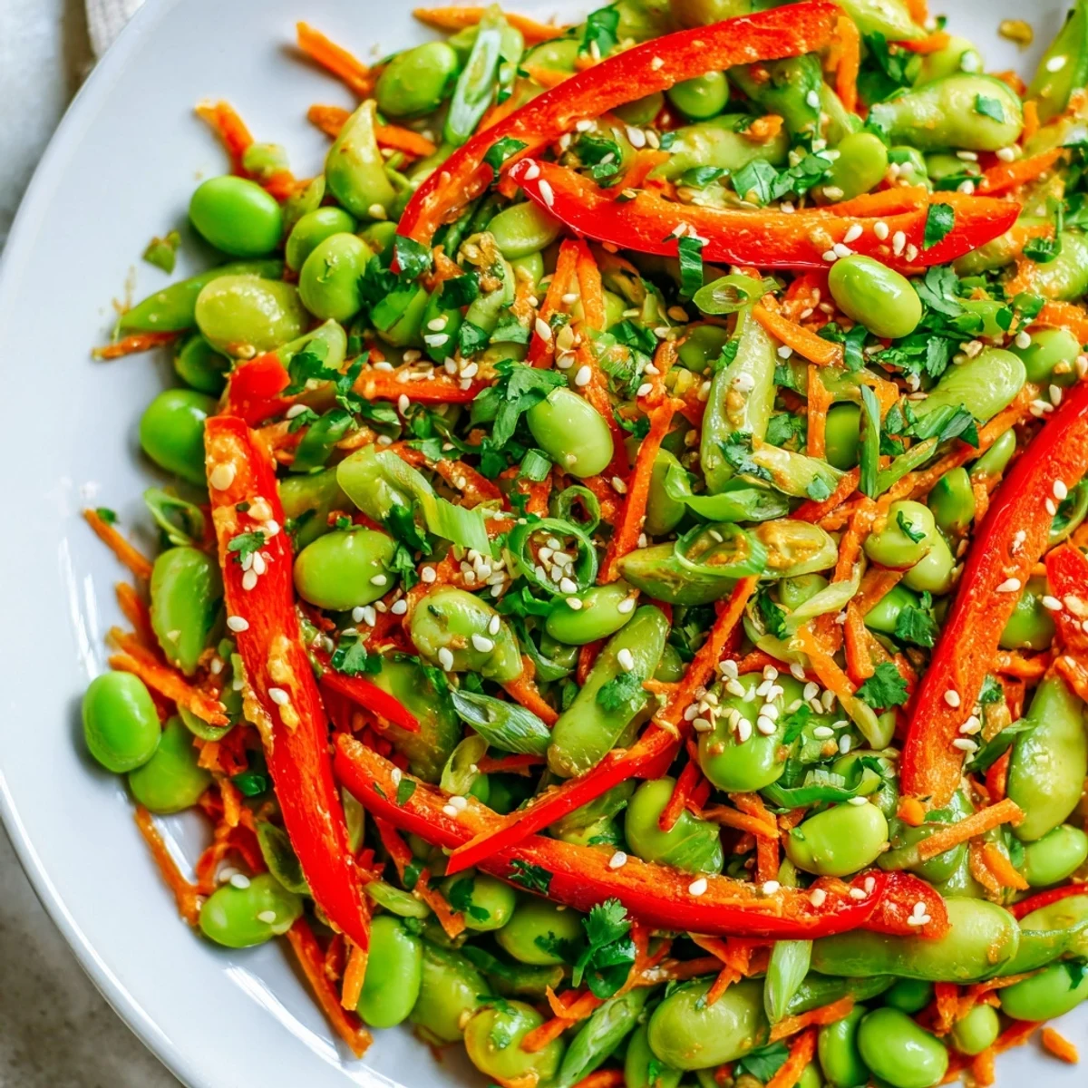 A bowl of delicious Asian edamame salad with protein-packed edamame and a savory dressing.