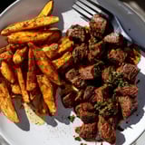 Flavorful Cajun steak bites seared to perfection, served with piping hot fries.  