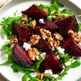 A delicious Roasted Beet Walnut Salad: tender beets, crunchy walnuts, and creamy goat cheese drizzled with vinaigrette.