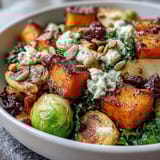 Colorful autumn harvest bowl featuring tender grains and warm, sweet roasted apple slices.