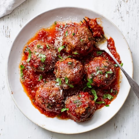 Tender Tomato Wine Slow-Baked Meatballs nestled in rich, savory sauce, perfect for dinner.  