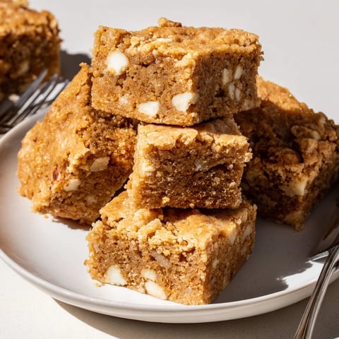 Buttery Maple Vanilla Blondie Bars topped with a golden crust and white chocolate chips.  