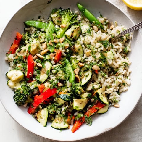 Vibrant herb butter veggie rice bowls topped with sautéed seasonal vegetables and fresh herbs.  