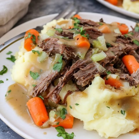 Slow Cooker Pot Roast with Mashed Potatoes, tender beef served over creamy potatoes.  