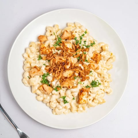 Creamy One-Pot Honey BBQ Chicken Mac and Cheese topped with crunchy onions and parsley.  
