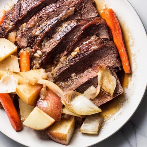 Steaming Sunday Pot Roast with tender beef and roasted vegetables, ready to serve and enjoy.