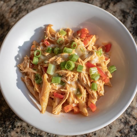 Buffalo Chicken Pasta Skillet in a skillet; creamy sauce with melted cheese and fresh green onions.