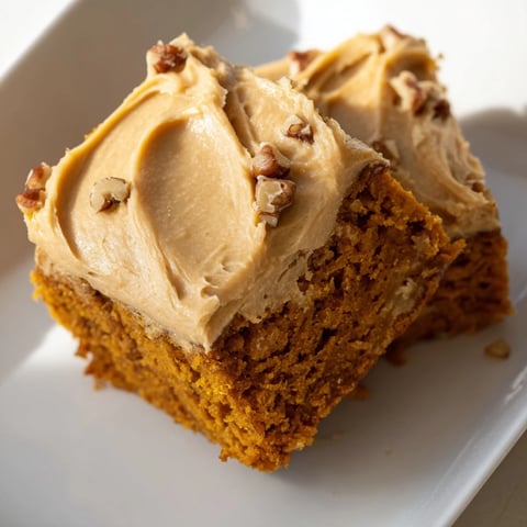 Golden, frosted pumpkin bars, a fall dessert favorite, perfect with a warm drink.