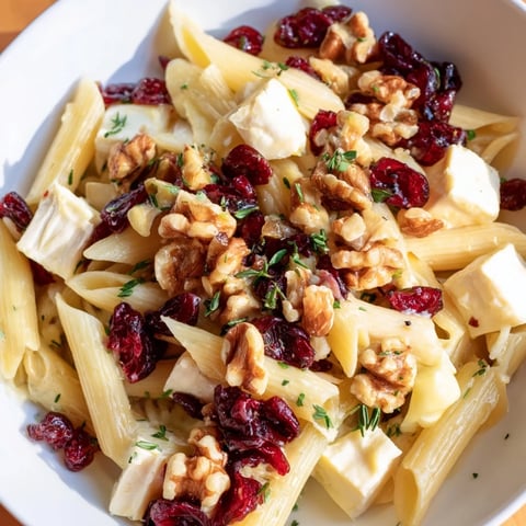 Creamy Baked Brie & Cranberry Pasta, a flavorful dish with melted cheese and juicy cranberries.