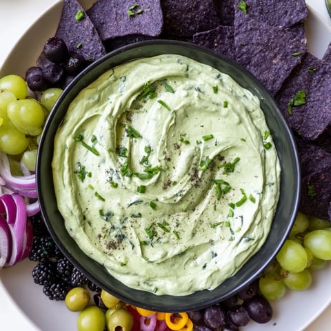 Bubbling Witchs Brew Cauldron dip with dark ingredients creates a spooky appetizer for Halloween.