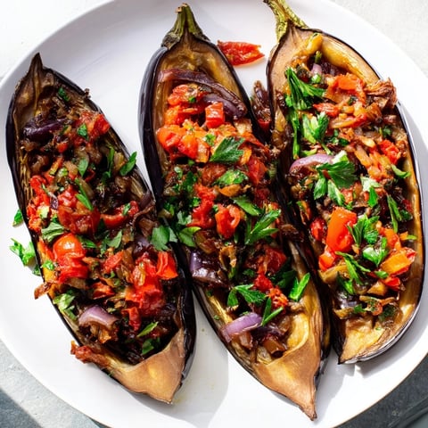 Golden-brown Imam Bayildi, a Turkish vegetarian delight of tender baked eggplant stuffed generously, ready to serve.