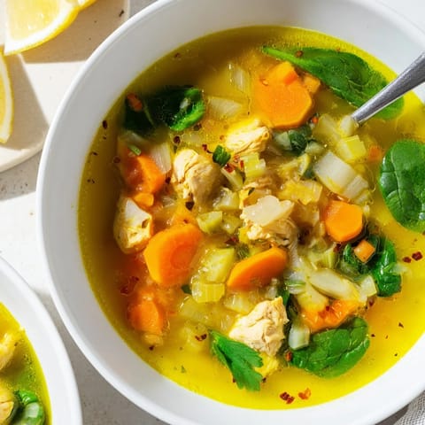 Vibrant Golden Turmeric Chicken Soup, loaded with spices and wholesome vegetables for a cozy meal.  