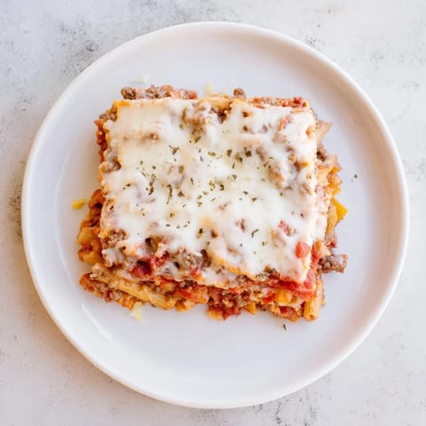 Savor the rich flavors of Cheesy Beef & Penne Bake, perfect for family gatherings.  