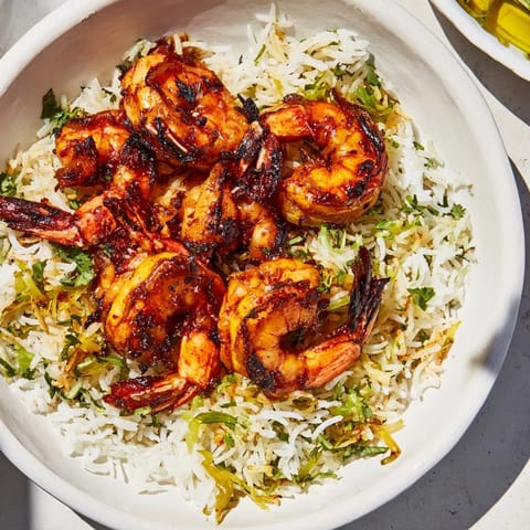 Smoky chipotle grilled shrimp served over fluffy rice, a complete meal full of zesty flavors.