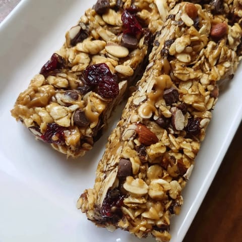 Close-up of freshly baked homemade granola bars, featuring a mix of textures and delicious ingredients.