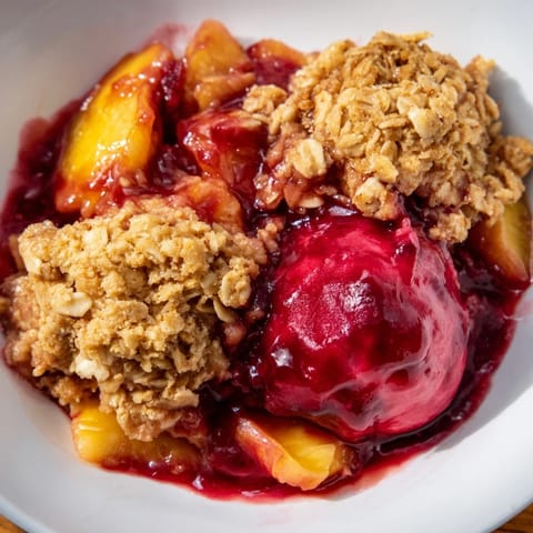 Sweet, bubbly Fruit Crisp with frozen fruit, ready to serve with creamy vanilla ice cream.