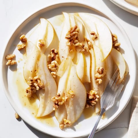 Thinly sliced pears with sweet honey drizzled over, ready for a delicious, quick snack.