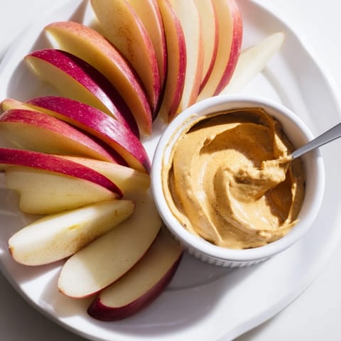 Enjoy sweet, juicy apple slices with a side of homemade peanut butter dip for an easy treat.