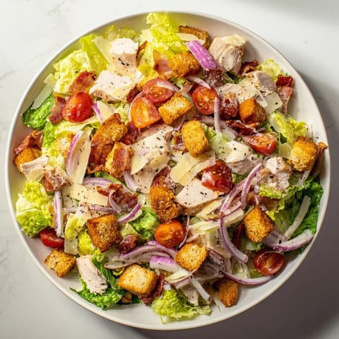 A fresh, flavorful Costco Chicken Bake Salad Bowl featuring juicy chicken, crunchy croutons, and Parmesan cheese.