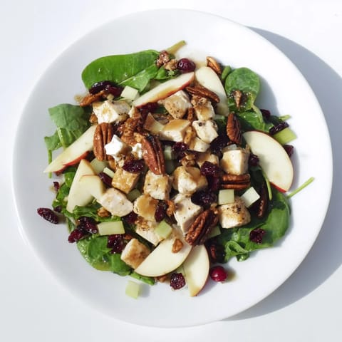Tossed Chicken and Apple Winter Salad, offering a beautiful mix of textures with a vibrant, colorful presentation.