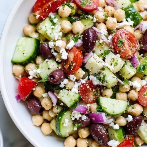 A refreshing bowl of Mediterranean Chickpea Salad, perfect for a light lunch, with bright, fresh ingredients.