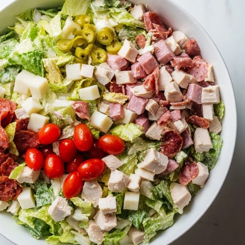 Italian Deli Chopped Chicken Salad topped with salami, provolone, and pepperoncini.