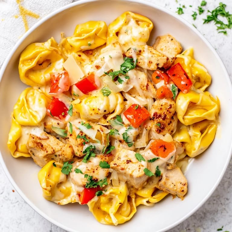 Imagine the aroma: flavorful Zesty Cajun Garlic Parmesan Chicken Tortellini, ready for a satisfying, spicy dinner.