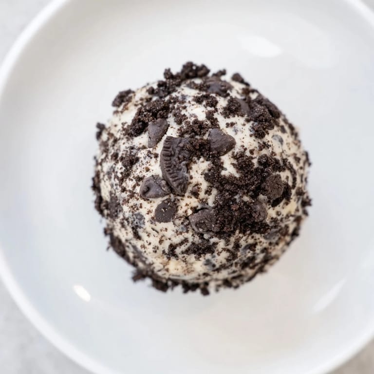 These glistening Cream Cheese Oreo Protein Balls feature a delightful mix of flavors and textures, perfect snacking.