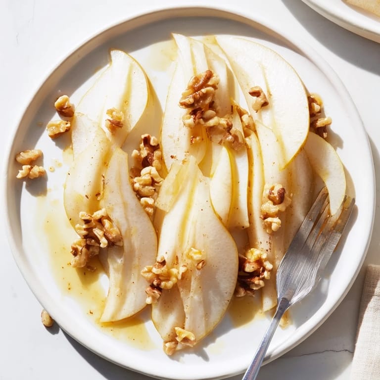 Thinly sliced pears with sweet honey drizzled over, ready for a delicious, quick snack.